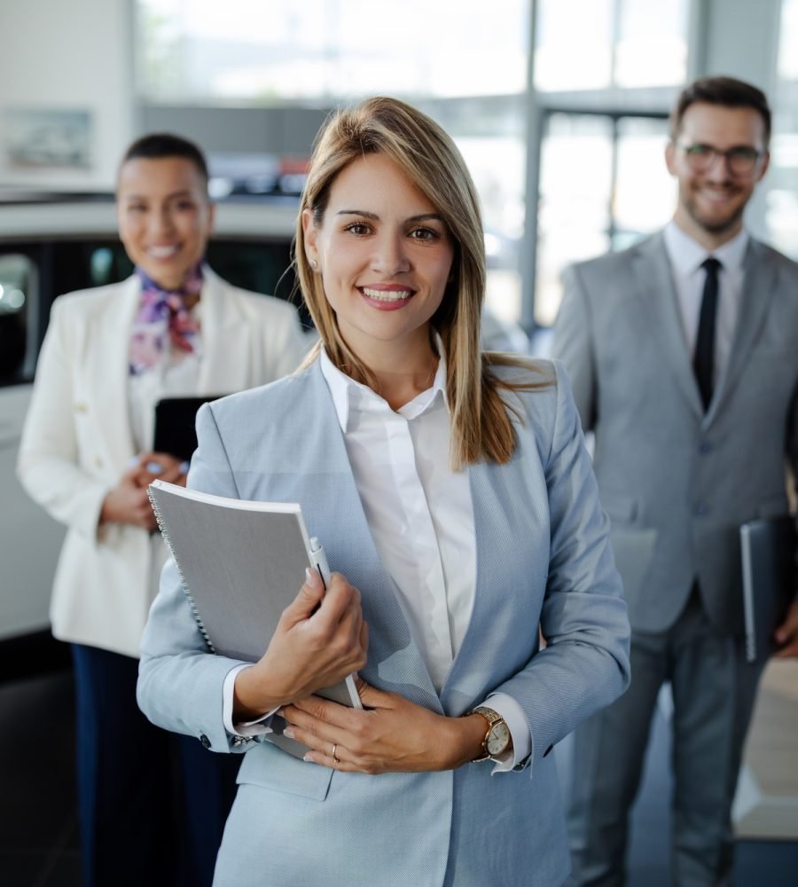 salesteam-in-dealership-three-beautiful-consultants-or-managers-in-elegant-suit-looking-on-camera-.jpg